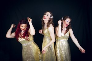 The Dazzlettes all smiles and gold glittery dresses